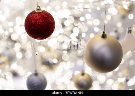 Festive Christmas tree composition decorated with baubles, bows, animal ornaments, glowing garlands. Cozy holiday decorations warm New Year atmosphere Stock Photo
