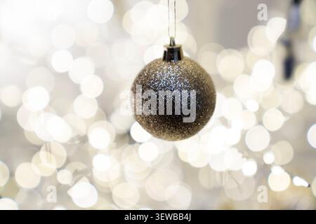 Festive Christmas tree composition decorated with baubles, bows, animal ornaments, glowing garlands. Cozy holiday decorations warm New Year atmosphere Stock Photo