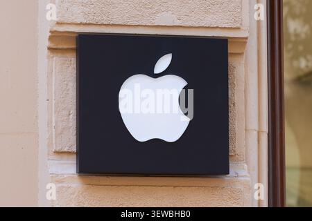 Apple company logo sign mounted on store exterior wall. Valencia, Spain - March 19, 2023. Stock Photo