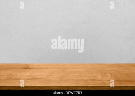 Empty wooden tabletop against a dark gray wall background. Minimalist studio mockup for product display and promotional advertising. Stock Photo