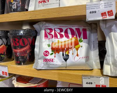 Khimki, Russia - June 25, 2026: BBOM creamy rose-flavored snack packaging displayed on a wooden shelf in a grocery store with various products Stock Photo