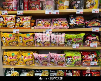 Khimki, Russia - June 25, 2026: Variety of instant noodles displayed on supermarket shelf, including Buldak and Samyang brands in colorful packaging Stock Photo
