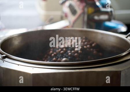 Fresh aromatic coffee beans being roasted in a roasting machine, Thailand, 31 January, 2025 Stock Photo