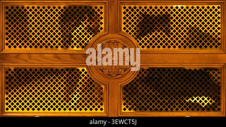 Symmetrical shot of decorative wooden panel with carved rosette and lattice ornament Stock Photo