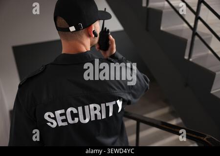 Bodyguard in uniform using walking down stairs Stock Photo