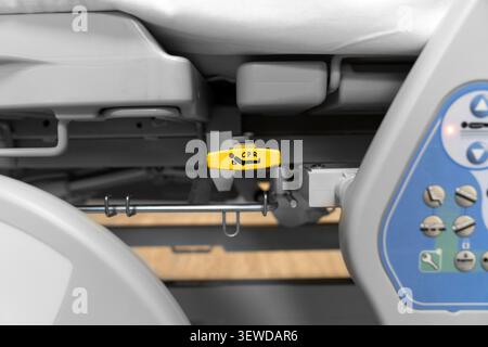 Hospital bed CPR release lever in a modern medical facility. Essential safety feature for emergency care and rapid life support response. Stock Photo