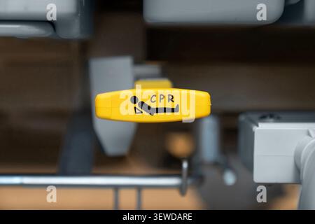 Hospital bed CPR release lever in a modern medical facility. Essential safety feature for emergency care and rapid life support response. Stock Photo
