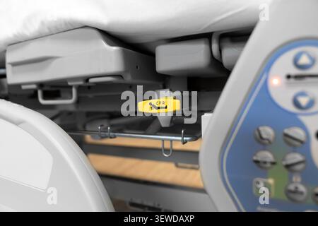 Hospital bed CPR release lever in a modern medical facility. Essential safety feature for emergency care and rapid life support response. Stock Photo