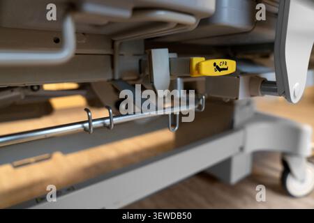 Hospital bed CPR release lever in a modern medical facility. Essential safety feature for emergency care and rapid life support response. Stock Photo