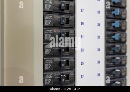 Photos of 20 amp circuit breakers in electrical panels.  Designed safely distribute electricity and protect circuits from overloads and faults. Stock Photo