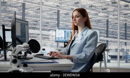 Reviewing microchip production operations, PC software and man with woman inside factory workplace. Improving semiconductor hardware performance, work and experts in RD office, camera A Stock Photo