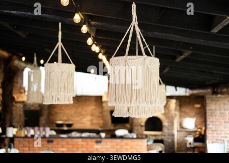 Handmade Macrame Pendant Light in Cozy Rustic Interior Stock Photo