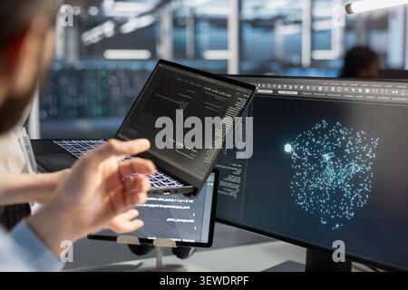 Software developer uses a tablet to run diagnostics, update servers and check infrastructure performance. Stock Photo