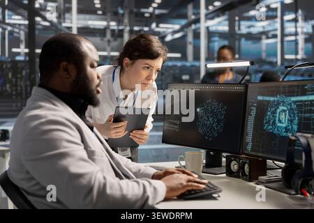 Data center manager reviews artificial intelligence systems and machine learning processes inside a data center. Stock Photo
