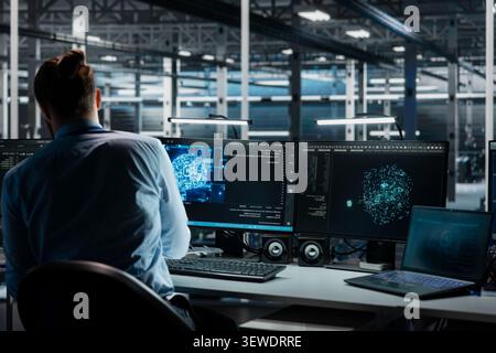 Software developer reviews artificial intelligence systems and machine learning processes inside a data center. Stock Photo
