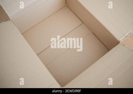 Open empty brown cardboard box for delivery package Stock Photo