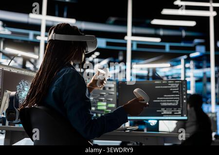 Data center technician uses a VR headset to inspect AI neural networks and server systems in a high-tech facility. Stock Photo