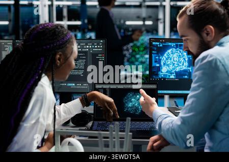 Computer scientists set up improved server rack systems in a server room with artificial intelligence support. Stock Photo