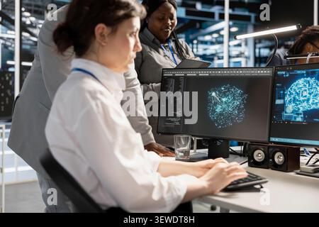 Data center colleagues collaborate on coding and AI automation scripts while reviewing server infrastructure together. Stock Photo