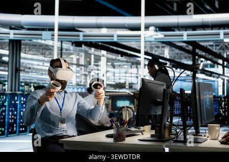 Data center engineer uses a VR headset to inspect AI neural networks and server systems in a high-tech facility. Stock Photo