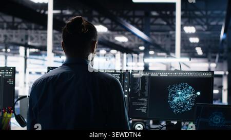 Overjoyed data center engineer dances on a chair after successfully analyzing datasets with machine learning tools. Stock Photo
