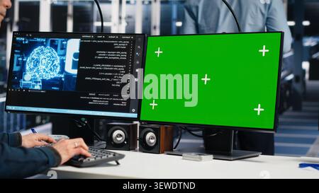 Software developer uses a green screen computer to manage AI systems, machine learning workflows and server performance. Stock Photo