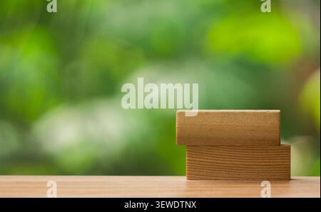 Two Wooden Blocks on Table with Green Background Stock Photo