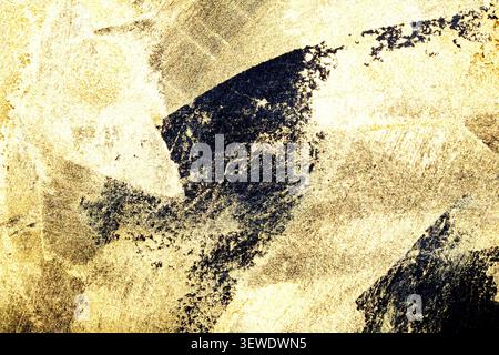 Gold metallic shiny paint leaf on black background Stock Photo