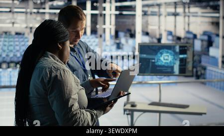 Data center engineering team manages software updates in a server room to keep data center systems stable. Stock Photo