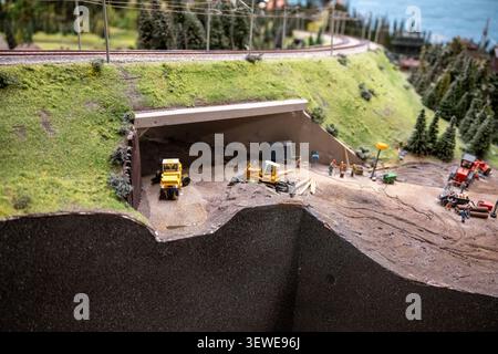 Hamburg, Germany - 4 Apr 25: Cutaway view of a model tunnel construction site with excavators and workers at Miniatur Wunderland, Hamburg, Germany. Stock Photo