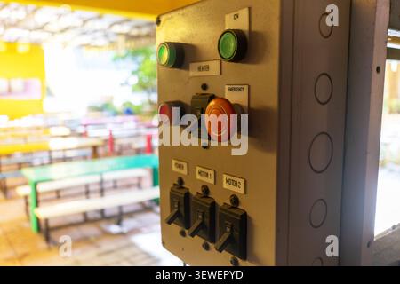 Close-up of an outdoor control panel with switches and buttons used to operate industrial machinery or systems in an outdoor environment, featuring sa Stock Photo