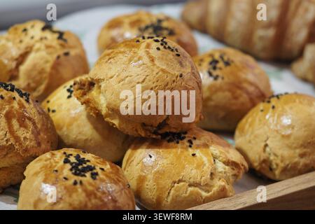 Freshly baked rolls on a tray at a bakery shop Stock Photo