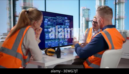 Engineers Use Computers To Monitor Automated Controls At Oil Plant. Stock Photo