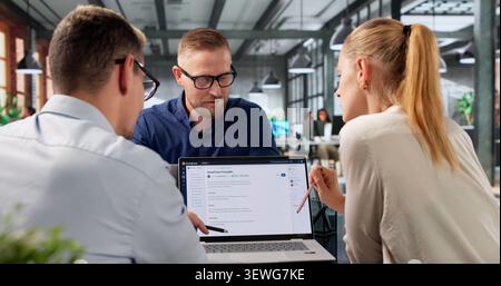 Diverse Team Collaborates On AI-powered Software Using Laptops And Cloud Systems. Stock Photo