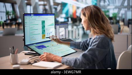 Experienced Executive Woman Uses Digital Dashboard To Track Company’s Progress. Stock Photo