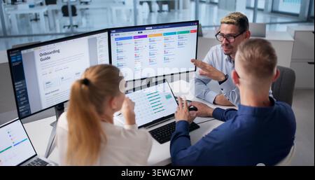 Human Resources Manager Leads Diverse Team Using HR Software Daily Tasks Stock Photo