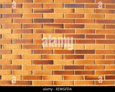 Orange brick facade creating a uniform brickwork pattern backdrop Stock Photo