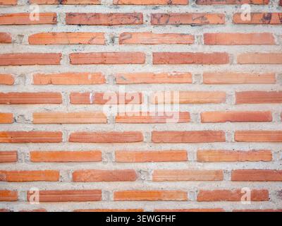 Brick wall with strong horizontal lines and varied orange and red tones Stock Photo
