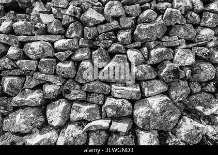 Drystone wall stones stacked tightly together in black and white Stock Photo