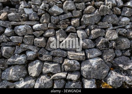 Drystone wall stones stacked tightly together filling frame Stock Photo
