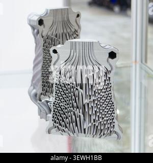 Objects heat exchanger with conformal cooling channels and filter or heat exchange element printed on 3D printer. Models printed on 3D printer from metal powder. Selective Laser Melting. SLM. Additive Stock Photo