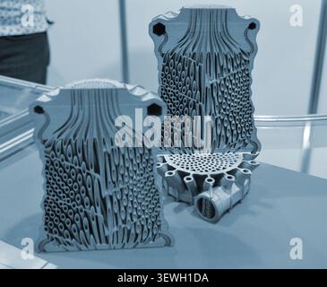 Objects heat exchanger with conformal cooling channels and filter or heat exchange element printed on 3D printer. Models printed on 3D printer from metal powder. Selective Laser Melting. SLM. Additive Stock Photo