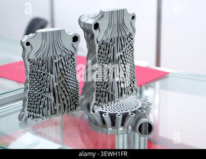 Objects heat exchanger with conformal cooling channels and filter or heat exchange element printed on 3D printer. Models printed on 3D printer from metal powder. Selective Laser Melting. SLM. Additive Stock Photo