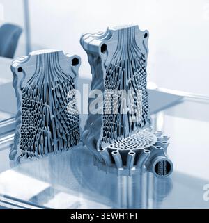 Objects heat exchanger with conformal cooling channels and filter or heat exchange element printed on 3D printer. Models printed on 3D printer from metal powder. Selective Laser Melting. SLM. Additive Stock Photo