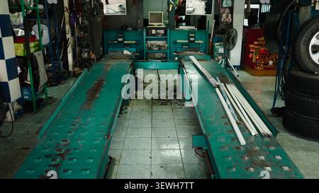 Auto repair shop interior with car lift ready for vehicle maintenance service Stock Photo