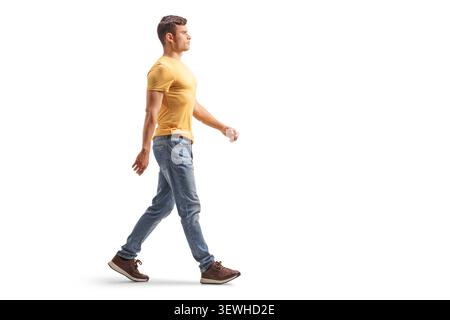 Young man walking in profile view isolated on white background Stock Photo