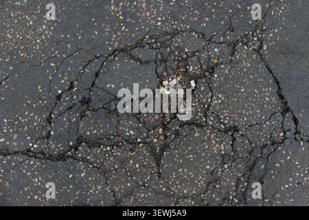 ABSTRACT BACKGROUND TEXTURE OLD CRACKED ASPHALT PAVEMENT Stock Photo