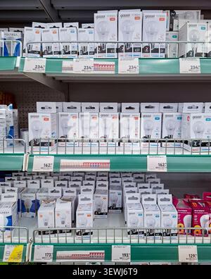 SVORONEZH, Russia - April 05, 2026.helves hold several rows of white cardboard boxes containing Gauss brand LED light bulbs in a Russian supermarket. Stock Photo