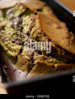Delicious marbled chocolate and matcha tea loaf cake sliced on a wooden board Stock Photo
