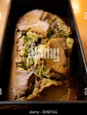Delicious marbled chocolate and matcha tea loaf cake sliced on a wooden board Stock Photo